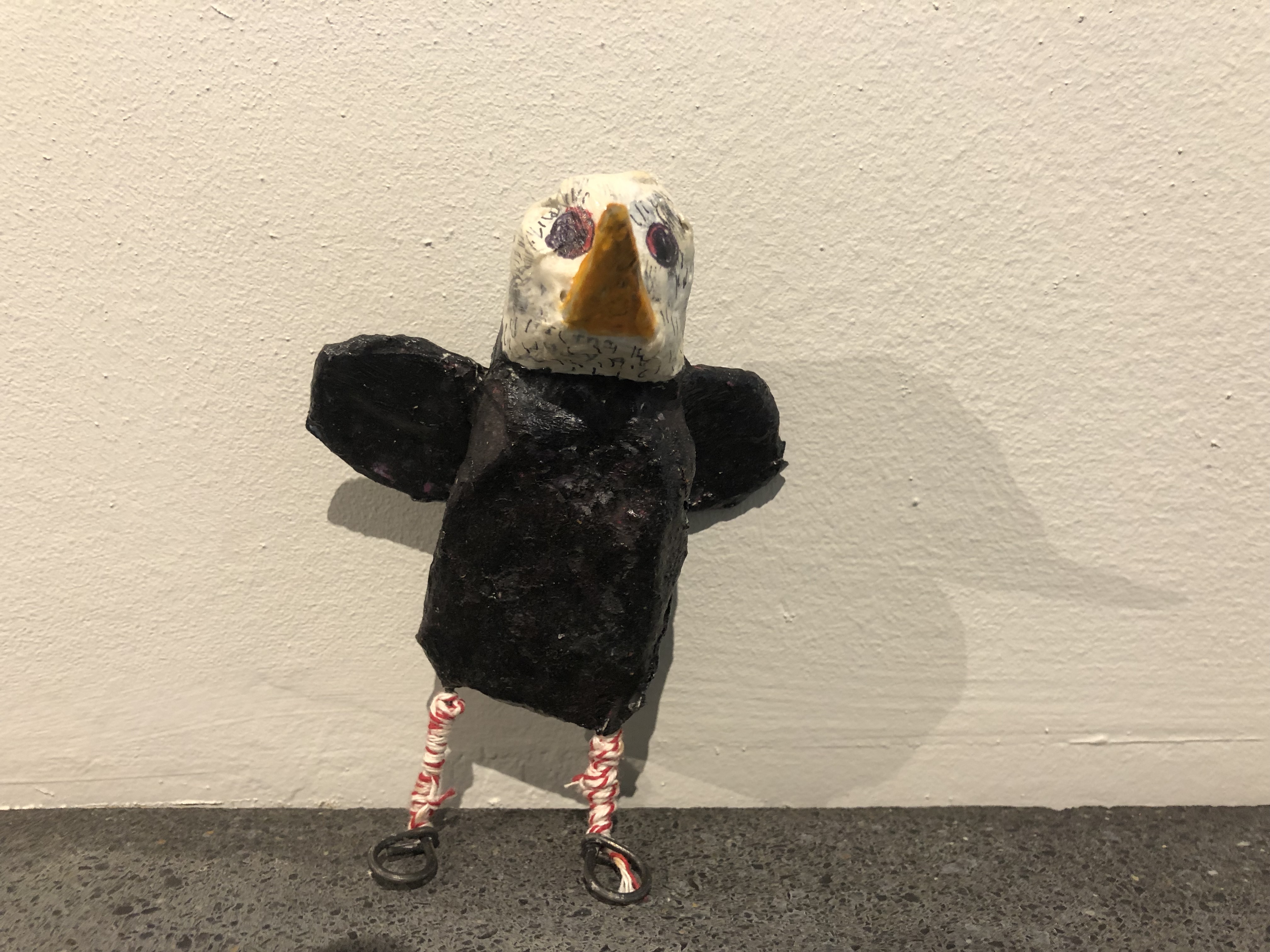 Paper-mache bald eagle with small round wings.